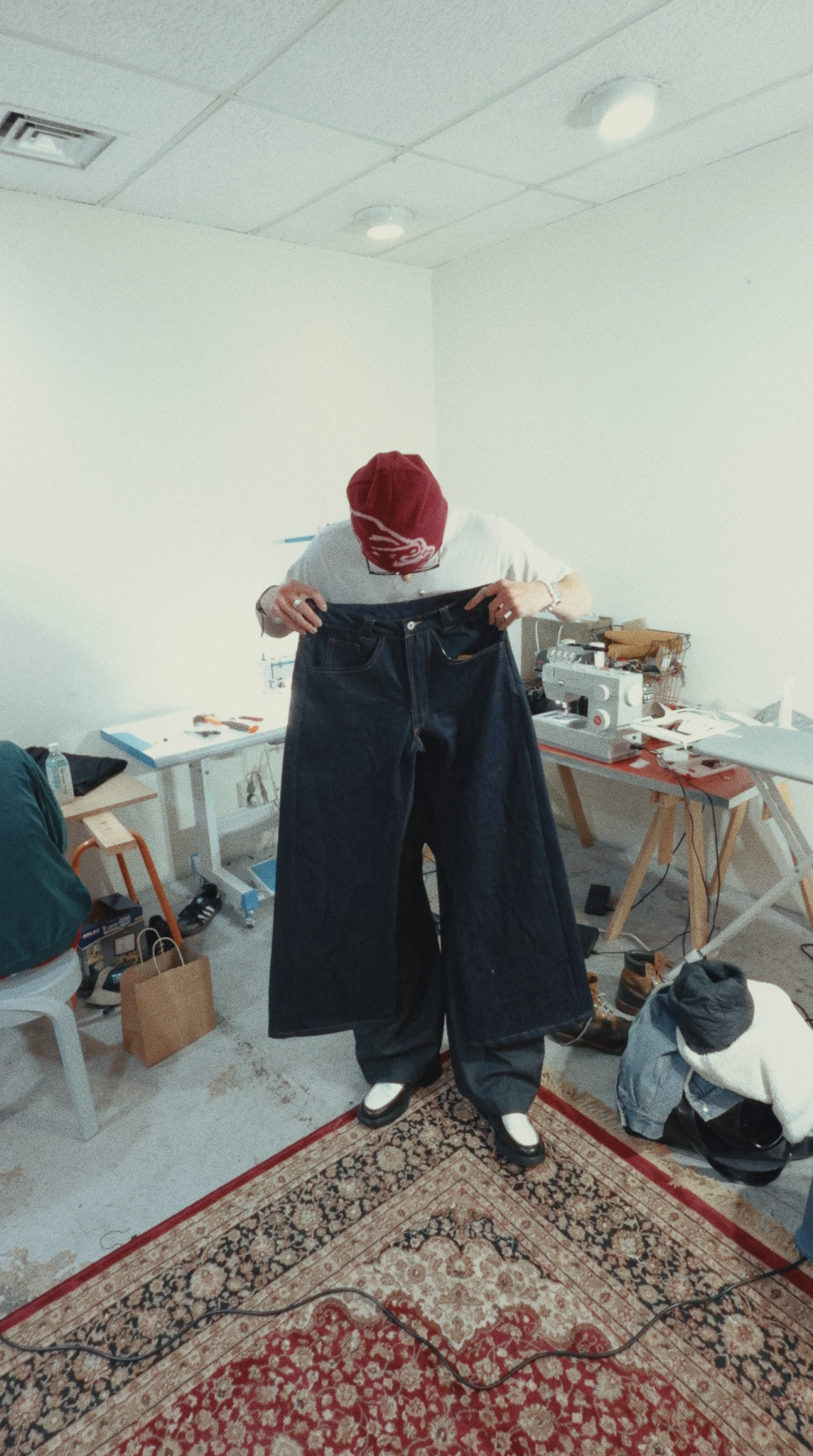 Callum Godfrey holding a finished pair of bespoke jeans